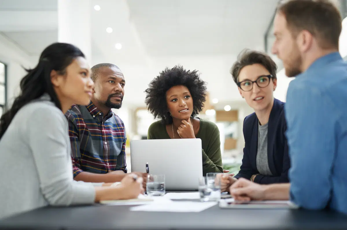 Pensive HR team reviewing computer — employee benefits enrollment data review